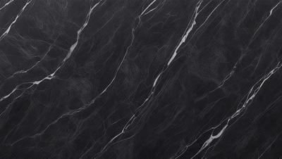 The primary subject of the image is a black marble countertop. The setting is a kitchen, with the countertop being the main focus of the scene. The visual style is a close-up of the marble countertop, showcasing its texture and pattern. The colors and mood of the image are predominantly dark, with the black marble providing a striking contrast against the darker background.
