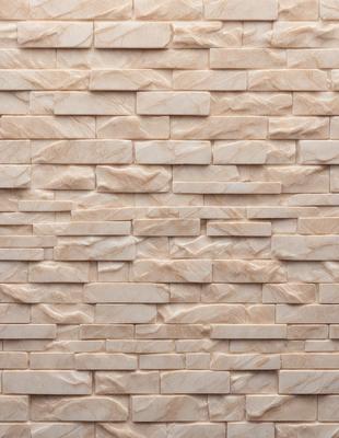 The image features a large, white brick wall with a patterned design. The wall is made of marble, giving it a luxurious and elegant appearance. The brick pattern adds texture and depth to the wall, making it an interesting focal point in the scene.