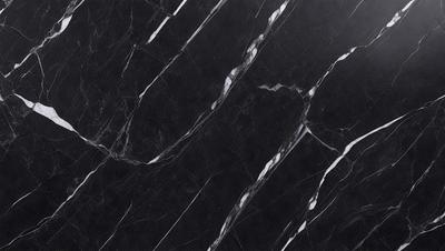 The primary subject of the image is a black marble countertop. The setting is a kitchen, with the countertop being the main focus of the scene. The visual style is a close-up of the marble countertop, showcasing its texture and pattern. The colors and mood of the image are predominantly black, giving it a sleek and modern appearance.