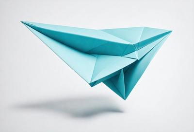 The primary subject of the image is a blue paper airplane. The setting is a white background, and the visual style is a photo. The colors and mood of the image are predominantly blue, giving it a calm and serene atmosphere.