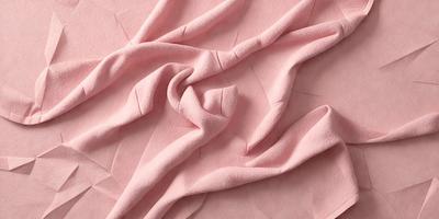 The primary subject of the image is a pink fabric, which is the main object, scene, or focus of the image. The setting or background is a pink surface, and the visual style is a photo. The colors and mood of the image are predominantly pink, creating a warm and inviting atmosphere.