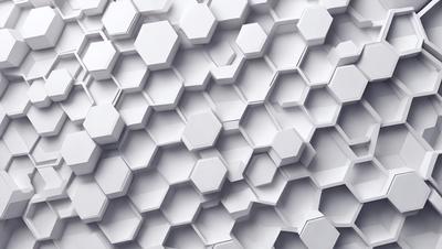 The primary subject of the image is a white wall with a pattern of hexagonal shapes. The setting is a white wall, and the visual style is a close-up of the wall. The dominant colors are white, and the overall atmosphere is clean and minimalistic.