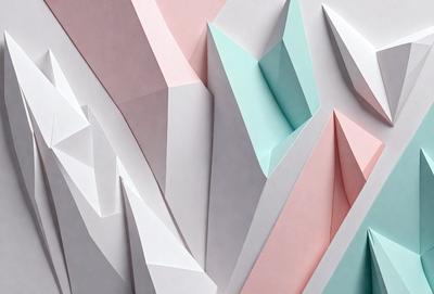 The primary subject of the image is a large, three-dimensional paper sculpture of a mountain. The sculpture is made of paper and is displayed on a pink and blue background. The visual style of the image is a combination of digital art and illustration, creating a unique and eye-catching representation of the mountain. The colors and mood of the image are predominantly pink and blue, giving the scene a warm and inviting atmosphere.