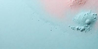 The primary subject of the image is a close-up of a blue surface with white bubbles on it. The setting appears to be a white wall, and the visual style is a photo. The dominant colors in the image are blue and white, creating a calm and soothing atmosphere.