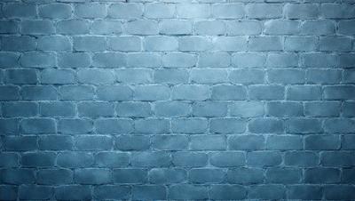 The primary subject of the image is a brick wall. The setting is a blue brick wall, which serves as the backdrop for the scene. The visual style of the image is a photo, capturing the brick wall in detail. The dominant colors in the image are blue and grey, creating a calm and serene atmosphere.