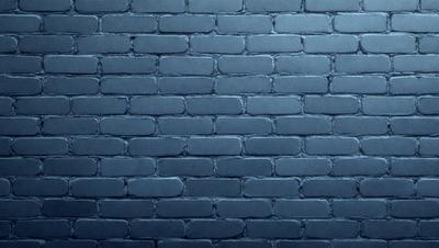 The primary subject of the image is a brick wall. The setting is a dark room, and the visual style is a photo. The dominant colors are blue and gray, creating a moody atmosphere.