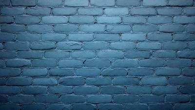 The primary subject of the image is a blue brick wall. The setting is a brick wall, and the visual style is a photo. The dominant colors are blue and white, creating a calm and serene atmosphere.
