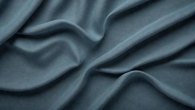 The primary subject of the image is a blue fabric, possibly a piece of cloth or a curtain. The setting is a room with a blue background, which creates a cohesive and visually appealing environment. The visual style of the image is a close-up of the blue fabric, showcasing its texture and details. The colors and mood of the image are predominantly blue, giving it a calm and serene atmosphere.