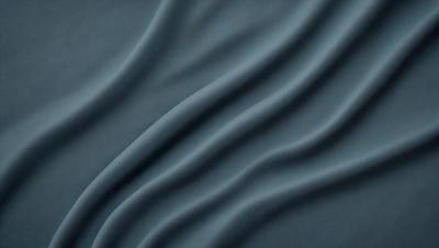 The primary subject of the image is a blue fabric, which appears to be a piece of cloth or a curtain. The setting is a dark room, and the visual style is a close-up of the fabric. The colors and mood of the image are predominantly dark and moody, with the blue fabric being the main focus.