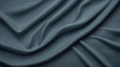 The primary subject of the image is a blue fabric, which is the main object, scene, or focus of the image. The setting or background is a blue cloth, and the visual style is a photo. The dominant colors and overall atmosphere are blue and dark, creating a moody and dramatic effect.