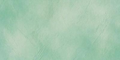 The primary subject of the image is a green wall with a patterned texture. The setting is a room with a green wall, and the visual style is a close-up of the wall. The colors and mood of the image are predominantly green, creating a calm and soothing atmosphere.