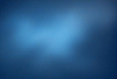 The primary subject of the image is a blue sky with a few clouds. The setting is a clear day with a cloudy sky, and the visual style is a natural, outdoor atmosphere. The colors and mood of the image are predominantly blue, creating a calm and serene ambiance.