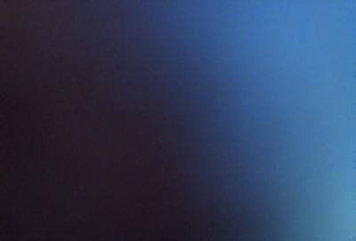 The primary subject of the image is a blue background with a red hue. The setting appears to be a dark room, and the visual style is a close-up of the blue and red background. The colors and mood of the image are predominantly dark and moody, with the blue and red hues creating a striking contrast.