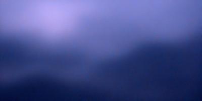 The primary subject of the image is a cloudy sky. The setting is a dark, cloudy day with a purple hue. The visual style is a photo, capturing the beauty of the cloudy sky. The colors and mood of the image are dark and moody, creating a sense of mystery and depth.