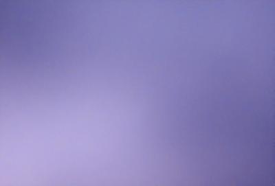 The primary subject of the image is a purple sky. The setting is a cloudy sky, and the visual style is a photo. The colors and mood of the image are predominantly purple, creating a calm and serene atmosphere.
