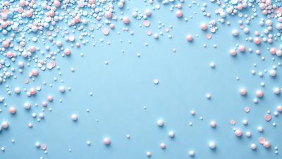 The primary subject of the image is a blue background with a pattern of pink and white balls scattered across it. The setting appears to be a wall or a surface with a visually appealing design. The visual style of the image is a combination of photo and digital art, creating a unique and eye-catching pattern. The dominant colors in the image are blue, pink, and white, giving it a calming and soothing atmosphere.
