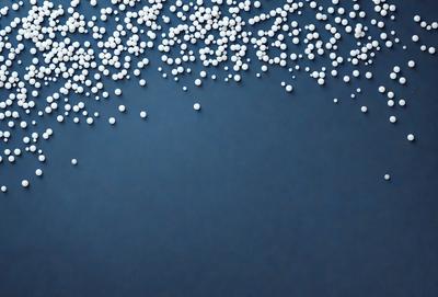 The primary subject of the image is a close-up of a blue surface with white specks on it. The setting appears to be a room with a blue wall. The visual style of the image is a close-up of the blue wall with white specks, which gives it a textured and patterned appearance. The colors and mood of the image are predominantly blue and white, creating a calm and serene atmosphere.