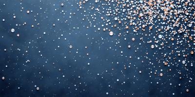 The primary subject of the image is a large number of small, round, shiny objects scattered across a dark background. The objects are arranged in a pattern, creating a visually appealing and intriguing scene. The setting appears to be a black surface, which contrasts with the brightness of the objects. The visual style of the image is a combination of photo and digital art, as it captures the beauty of the objects against a dark background. The colors and mood of the image are predominantly dark, with the bright
