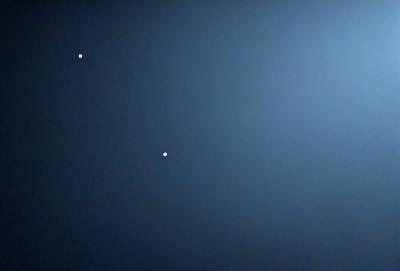 The primary subject of the image is the night sky, which is filled with stars. The setting is a dark, starry background, and the visual style is a photo of the night sky. The colors and mood of the image are predominantly dark and serene, with the stars providing a sense of depth and beauty.