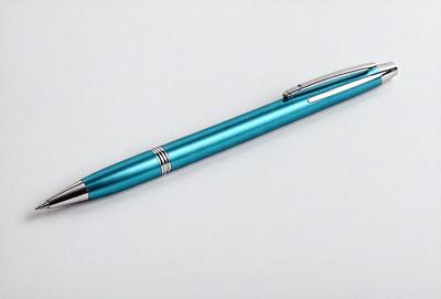The primary subject of the image is a blue pen. The pen is placed on a white surface, which serves as the setting or background. The visual style of the image is a photo, capturing the pen in detail. The dominant colors in the image are blue and white, creating a clean and simple atmosphere.