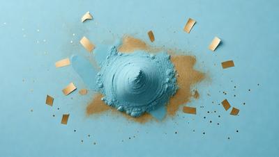 The primary subject of the image is a blue substance, possibly a powder or a liquid, with a sandy texture. The setting is a blue surface, possibly a table or a countertop. The visual style appears to be a combination of a photo and a digital art, illustration, or drawing. The colors in the image are predominantly blue and sandy tones, creating a calm and soothing atmosphere.