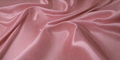 The primary subject of the image is a pink fabric, which is the main object, scene, or focus of the image. The setting or background is a pink sheet, and the visual style is a close-up of the fabric. The colors and mood of the image are predominantly pink, creating a warm and inviting atmosphere.