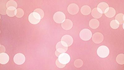 The primary subject of the image is a pink background with white circles. The setting is a pink surface, and the visual style is a pattern of white circles on a pink background. The dominant colors are pink and white, creating a warm and inviting atmosphere.