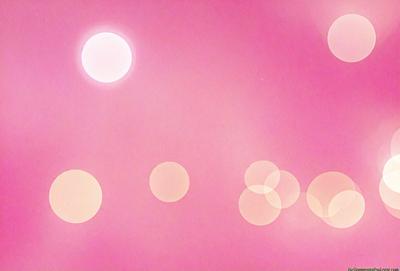 The primary subject of the image is a pink background with a pattern of circles. The setting is a pink sky, and the visual style appears to be a digital art or illustration. The dominant colors are pink and white, creating a warm and inviting atmosphere.