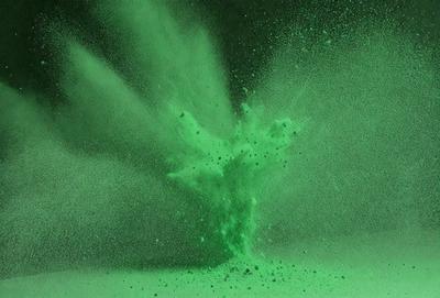 The primary subject of the image is a green explosion, which appears to be a digital art or illustration. The setting is a dark background, and the visual style is a combination of digital art and illustration. The colors and mood of the image are predominantly green, creating a vibrant and lively atmosphere.