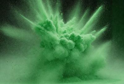 The primary subject of the image is a green, foamy substance, which appears to be a mixture of green and white colors. The setting is a dark background, which contrasts with the bright green substance. The visual style of the image is a close-up of the green substance, showcasing its texture and appearance. The colors and mood of the image are lively and energetic, with the green substance creating a sense of movement and dynamism.