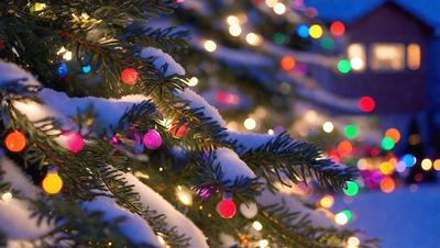 The primary subject of the image is a Christmas tree covered in snow and adorned with colorful lights. The tree is surrounded by a snowy landscape, creating a festive and wintry atmosphere. The visual style of the image is a photo, capturing the beauty of the snow-covered tree and its colorful lights. The colors and mood of the image are predominantly white and cold, with the warmth of the colored lights adding a touch of warmth to the scene.