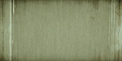 The primary subject of the image is a wall with a brown texture. The setting is a room with a wooden surface. The visual style is a close-up of the wall, showcasing its texture. The colors and mood of the image are warm and earthy, with a focus on the brown tones of the wall.