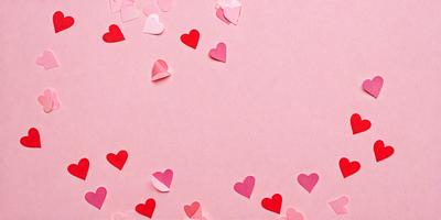 The primary subject of the image is a collection of pink hearts, which are scattered across a pink background. The hearts are made of paper and are arranged in various shapes and sizes. The setting is a pink wall, which serves as the backdrop for the hearts. The visual style is a combination of digital art and illustration, creating a playful and romantic atmosphere. The dominant colors are pink and red, which evoke feelings of love and affection.