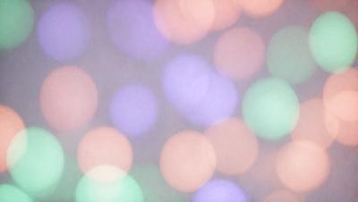 The primary subject of the image is a close-up of a colorful, swirling pattern of lights. The setting is a white background, which contrasts with the vibrant colors of the lights. The visual style is a combination of a photo and digital art, creating a unique and eye-catching pattern. The colors and mood of the image are lively and energetic, with the swirling lights evoking a sense of movement and dynamism.