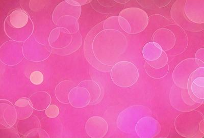 The primary subject of the image is a pink background with a pattern of white circles. The setting is a pink background with a pattern of white circles. The visual style is a pattern of white circles on a pink background. The colors and mood are predominantly pink and white, creating a warm and inviting atmosphere.