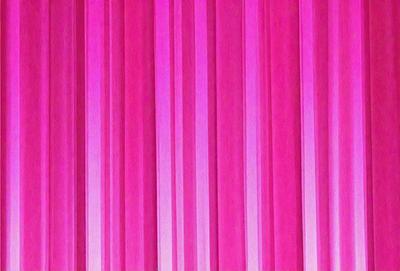The primary subject of the image is a pink striped wall. The setting is a room with a pink wall, and the visual style is a patterned wallpaper. The dominant colors are pink and white, creating a warm and inviting atmosphere.