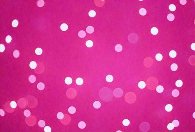 The primary subject of the image is a close-up of a pink background with a pattern of white dots. The setting appears to be a pink wall or a pink fabric. The visual style is a close-up of the pink background with white dots, which gives the image a digital art or illustration appearance. The colors and mood of the image are predominantly pink and white, creating a warm and inviting atmosphere.