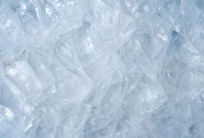 The primary subject of the image is a large, white, and clear crystal. The setting is a white background, which provides a clean and minimalistic appearance. The visual style is a close-up of the crystal, showcasing its intricate details. The colors and mood of the image are predominantly white, giving it a clean and serene atmosphere.