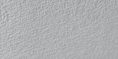 The primary subject of the image is a white wall with a patterned texture. The setting is a room with a white background. The visual style is a close-up of the wall, showcasing the intricate pattern. The colors and mood of the image are predominantly white, giving it a clean and minimalist appearance.