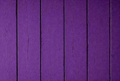 Purple wall with wooden planks.