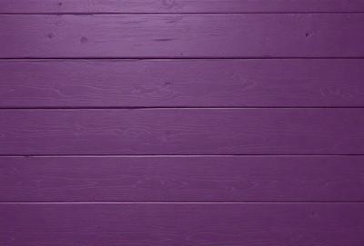 Purple wall with wooden planks.