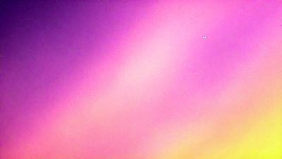 The primary subject of the image is a pink and purple sky, with a purple background. The sky appears to be a gradient, with the pink hue transitioning to the purple hue. The visual style of the image is a photo, capturing the natural beauty of the sky. The colors and mood of the image are vibrant and serene, creating a sense of tranquility and wonder.