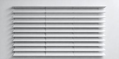 The primary subject of the image is a row of blinds, which are white in color. The setting is a white wall, and the visual style is a photo. The blinds are arranged in a vertical line, and the overall atmosphere is clean and minimalistic.