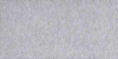 The primary subject of the image is a large, white, textured surface. The setting is a plain, empty room with no other objects or people visible. The visual style is a close-up of the white surface, which appears to be a piece of fabric or a wall with a textured pattern. The colors and mood of the image are predominantly white, giving it a clean and minimalist appearance.