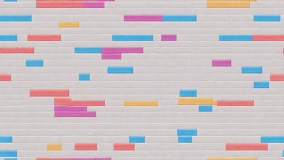 The primary subject of the image is a brick wall with a colorful pattern on it. The setting is a brick wall, and the visual style appears to be a combination of photo and digital art. The colors and mood of the image are vibrant and lively, with a mix of pink, blue, yellow, and green colors.