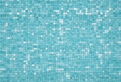 The primary subject of the image is a blue tile wall with a pattern of blue squares. The setting is a room with a blue tile floor, and the visual style is a close-up of the blue tile wall. The colors and mood of the image are predominantly blue, creating a calm and serene atmosphere.
