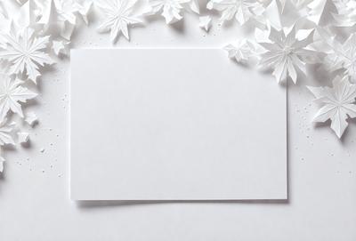 The primary subject of the image is a blank white card. The setting is a white table, and the visual style is a photo. The colors and mood of the image are predominantly white, giving it a clean and minimalist appearance.
