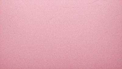 The primary subject of the image is a pink background with a few white threads on it. The setting is a close-up of the pink background, and the visual style appears to be a photo. The colors and mood of the image are predominantly pink and calm, creating a serene atmosphere.