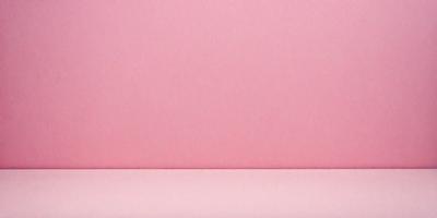 The primary subject of the image is a pink wall. The setting is a room with a pink wall, and the visual style is a photo. The dominant colors in the image are pink, and the overall atmosphere is warm and inviting.