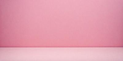 The primary subject of the image is a pink wall. The setting is a room with a pink wall, and the visual style is a photo. The dominant colors are pink, and the overall atmosphere is warm and inviting.